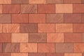 Abstract full-frame close-up of a wall of brown, terracotta-colored, and reddish rectangular bricks, showcasing their Royalty Free Stock Photo