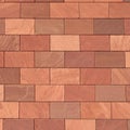 Abstract full-frame close-up of a wall of brown, terracotta-colored, and reddish rectangular bricks, showcasing their Royalty Free Stock Photo