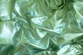 Abstract futuristic looking light green texture background. Silk sheets texture. Satin linens.