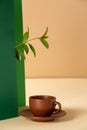 Abstract geometric background with a cup of coffee and a plant branch Royalty Free Stock Photo