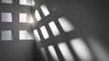 Abstract geometric light and shadow pattern created by sunlight through square openings on a textured wall in a minimalist Royalty Free Stock Photo