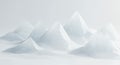 Abstract geometric mountain peaks with faceted surfaces rise from a soft white background, featuring subtle blue reflections and Royalty Free Stock Photo