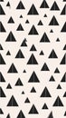 Abstract Geometric Pattern of Black Triangles on a Light Cream Background Royalty Free Stock Photo