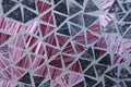 Abstract geometric pattern of pink and black triangles with glass texture. Design with dynamic lines and contrasting colors.