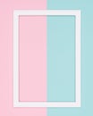 Abstract geometrical pastel blue and pink colored paper flat lay background. Minimalism template with empty picture frame. Royalty Free Stock Photo