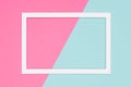 Abstract geometrical pastel blue and pink colored paper flat lay background. Minimalism template with empty picture frame.