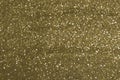 Sparkly glitter, dark golden background bokeh effect Royalty Free Stock Photo