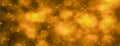 Abstract glitter gold and yellow bokeh glow in the dark on black background, banner panoramic horizontal overhead for decorating a Royalty Free Stock Photo