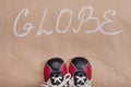 Abstract globe word, background paper, baby sneakers