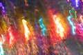 Abstract glowing background of multicolored chaotic neon rays as christmas candy canes on dark.