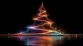 Abstract glowing Christmas tree made of swirling multicolored light trails with sparkles on black background and Royalty Free Stock Photo