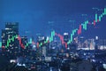 Abstract glowing forex chart on night city background. Trade, finance and invest concept.