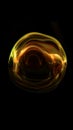 Abstract glowing golden energy sphere with fluid reflections and motion, symbolizing light, power, and transformation Royalty Free Stock Photo