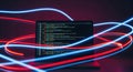 Abstract glowing neon lights surrounding a computer screen displaying lines of code creating a futuristic digital atmosphere Royalty Free Stock Photo