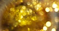 Abstract gold bokeh background. Golden holiday glowing backdrop. Defocused Background With Blinking Stars. Blurred Bokeh Royalty Free Stock Photo