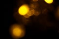 Abstract gold bokeh on black background. Defocused yellow lights, abstract texture Royalty Free Stock Photo