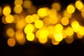 Abstract gold bokeh on black background. Defocused yellow lights, abstract texture Royalty Free Stock Photo