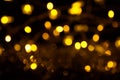 Abstract gold bokeh on black background. Defocused yellow lights, abstract texture Royalty Free Stock Photo