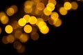 Abstract gold bokeh on black background. Defocused yellow lights, abstract texture Royalty Free Stock Photo