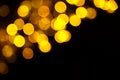 Abstract gold bokeh on black background. Defocused yellow lights, abstract texture Royalty Free Stock Photo