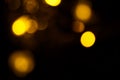 Abstract gold bokeh on black background. Defocused yellow lights, abstract texture Royalty Free Stock Photo
