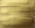 Abstract gold bronze glittering color surface. Paint smear brush stroke stain texture