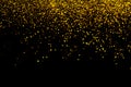 Abstract gold defocused glitter holiday background on black. Falling shiny sparkles. New year Christmas glowing backdrop