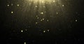 Abstract gold glitter particles background with shining stars falling down and light flare or glare overlay effect above for luxur