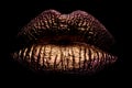 Abstract gold lips. Golden lips closeup. Gold metal lip. Beautiful makeup. Golden lip gloss on beauty female mouth