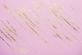 Abstract Gold potal brush strokes on pink pastel paper background or texture