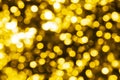 Abstract golden blurred bokeh background, defocused round yellow & white shiny dots texture, beautiful gold glowing pattern Royalty Free Stock Photo