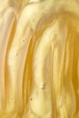 Abstract golden liquid background, paint splash, swirl pattern and water drops, beauty gel and cosmetic texture Royalty Free Stock Photo