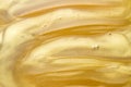 Abstract golden liquid background, paint splash, swirl pattern and water drops, beauty gel and cosmetic texture Royalty Free Stock Photo