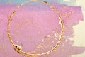 Abstract golden and pink watercolor stains, shiny round frame, background