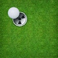 Abstract golf sport background of golf ball and golf hole on green grass background.