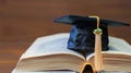 Abstract graduation cap over a book. E learning or Education concept Royalty Free Stock Photo