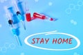 Abstract graphics with inscription stay home and syringe, vaccine