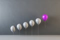 Abstract gray and purple ballons on interior wall background. Leadership and teamwork concept. Royalty Free Stock Photo