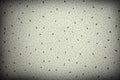 Abstract gray-white background with black dots and specks. Vignetted empty flat surface with an emphasis on the center. Space for Royalty Free Stock Photo