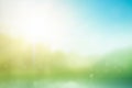 Abstract green bokeh blurred gradient in spring morning garden background Earth day concept: sun light meadow and blue sky on Royalty Free Stock Photo