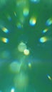 Abstract green glowing light rays and bokeh shapes creating dynamic energy burst background Royalty Free Stock Photo