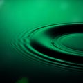 Abstract green liquid surface with ripples and concentric wave pattern on water Royalty Free Stock Photo