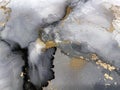 Abstract smoky grey background with gold. Alcohol ink. Fluid golden texture resembles marble, watercolor or aquarelle. Royalty Free Stock Photo