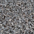 Abstract grey and beige gravel stone background, crushed gray stones and granite pieces texture, large detailed textured rough