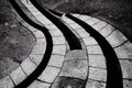 Abstract grey stone tiles paved winding walkway