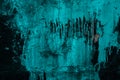 Abstract grunge background. Black and green wall. Cracked turquoise paint on the wall. Drips of green paint on a black wall. Patte