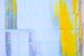 Abstract Grunge Background - white wall with yellow and blue dripping paint and large crack