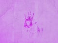 Abstract grunge handprint on the purple wall