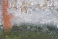 Creative background. Green, grey and orange rough weathered stone texture with moss, stucco and paint Royalty Free Stock Photo