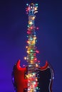 Abstract guitar with festive Christmas multicolor lights